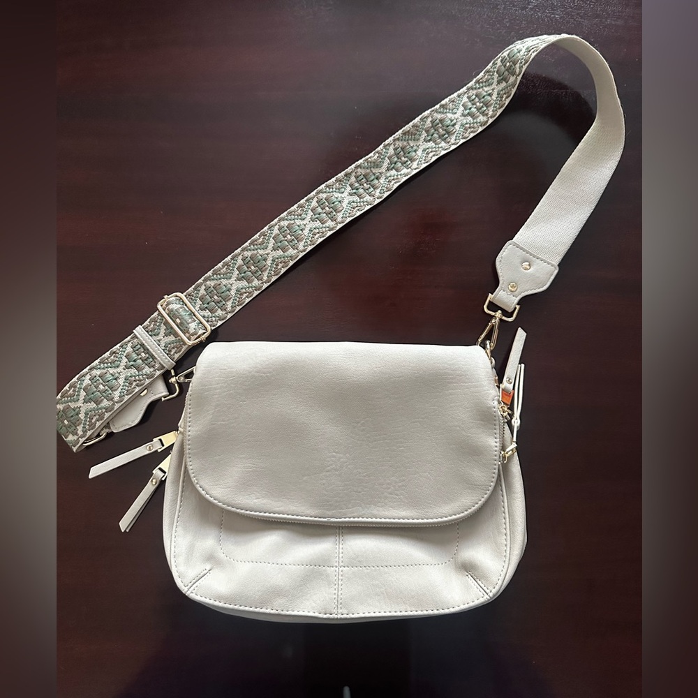 Miztique faux, leather crossbody bag with guitar strap.